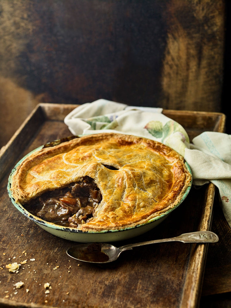 Fine art photographic print of a traditional Beef shin and Guiness pie. Photographer Andrew Montgomery.