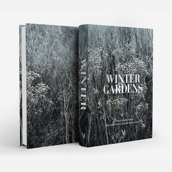 A hardcover book titled 'Winter Gardens' shown standing upright with its front cover and spine visible. The cover features a monochrome winter garden photograph in shades of gray, black, and white, with the title in large white serif text.